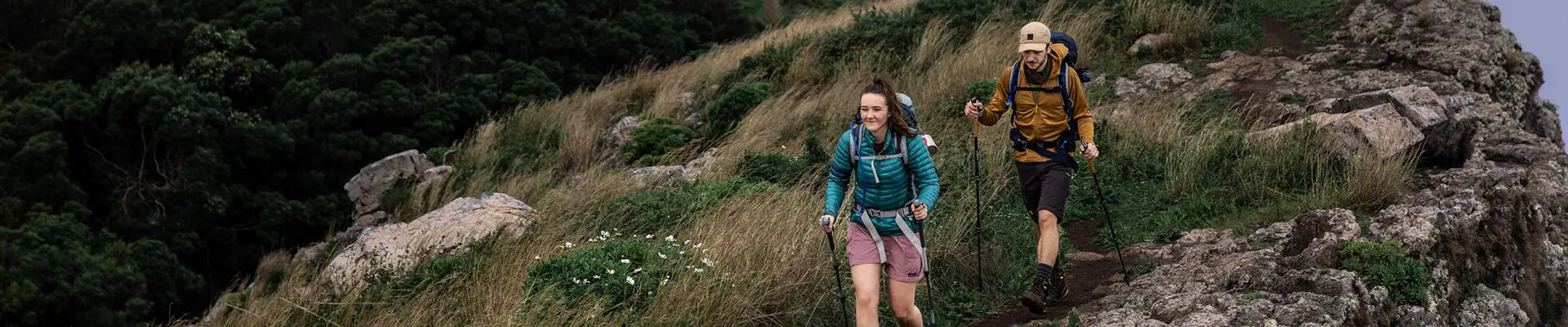 Mensen wandelen door de bergen en er zijn twee boekjes afgebeeld